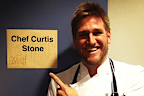 Curtis Stone posing in front of a door at the Grammys.
