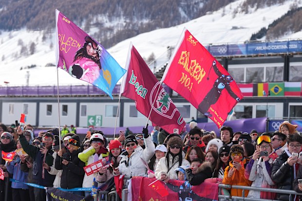 Chinese fans wave flags for silver medallist Eileen Gu after the women's freestyle skiing slopestyle final in Livigno.
