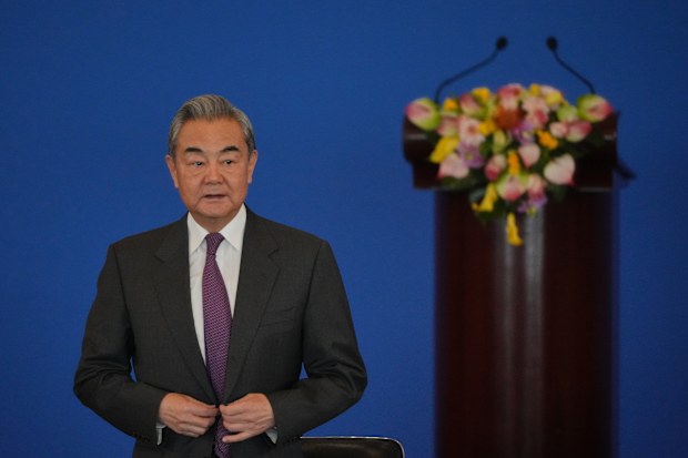 China's Foreign Minister Wang Yi looks as he arrives to deliver an opening speech for the annual symposium on the international situation and China's foreign relations held by China Institute of International Studies at the Diaoyutai State Guesthouse, in Beijing, Tuesday, Dec. 30, 2025. (AP Photo/Andy Wong)