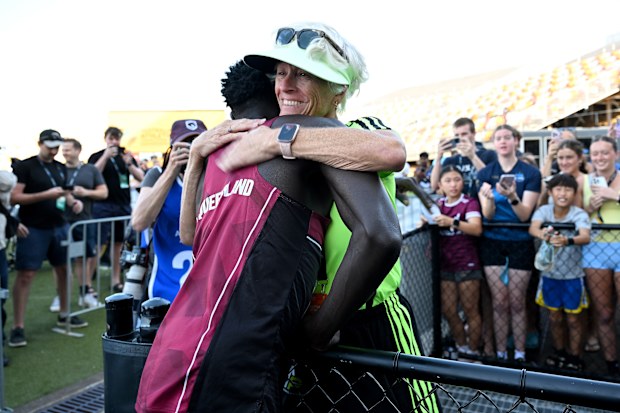 BRISBANE, AUSTRALIA - APRIL 18: Gout Gout embraces his coach Di Sheppard after winning the final of the Men's U20's 100m event during the 2026 Australian Athletics Junior Championships at Queensland Sport and Athletics Centre on April 18, 2026 in Brisbane, Australia. (Photo by Bradley Kanaris/Getty Images)