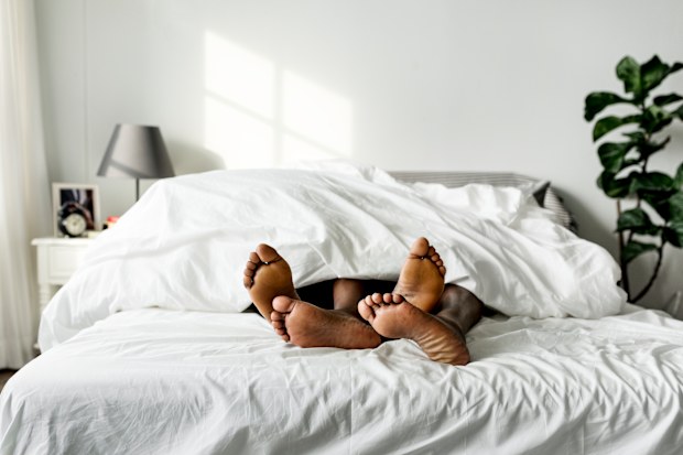 Black couple lying on bed together sex concept