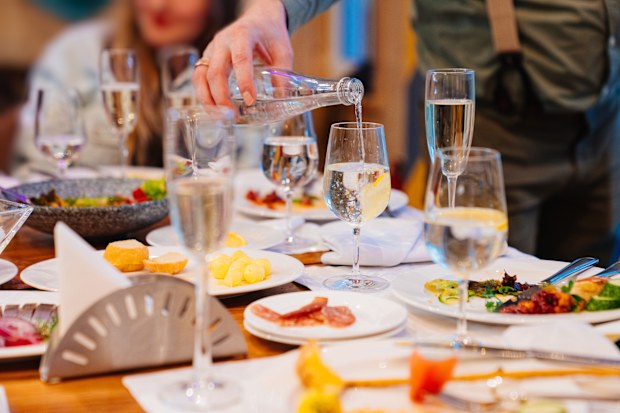 waiter pours water at restaurant