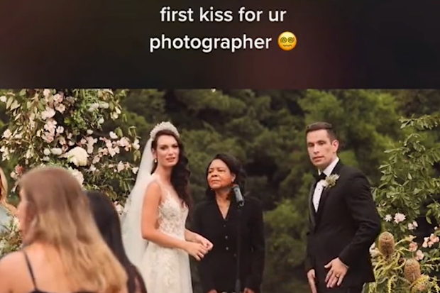 Wedding photographer interrupts couple mid first-kiss