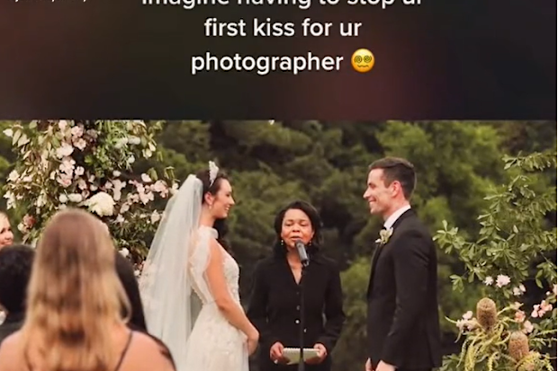 Wedding photographer interrupts couple mid first-kiss