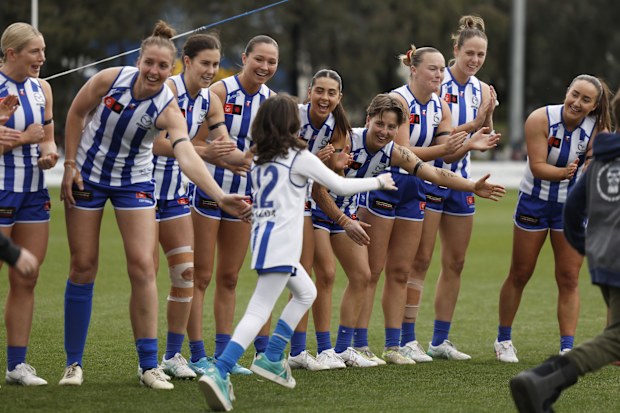 Kangaroos AFLW players high five Imogen Mulgrew during the home and away season.