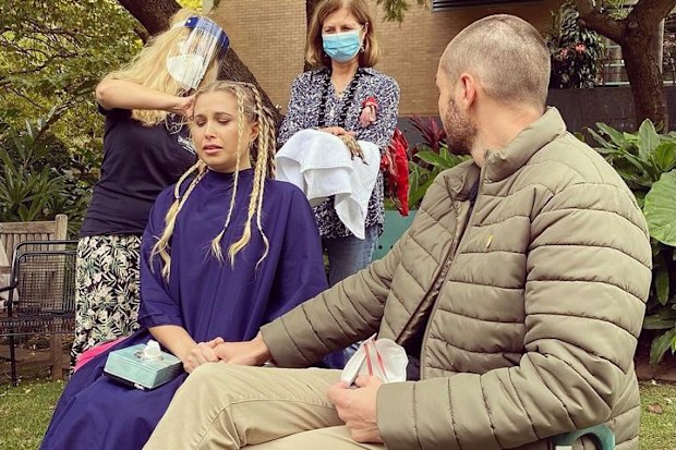 Simon held Hannah's hand as her head was shaved to make a wig.