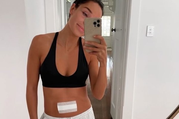 Kayla Itsines with a bandage on her stomach after endometriosis surgery.