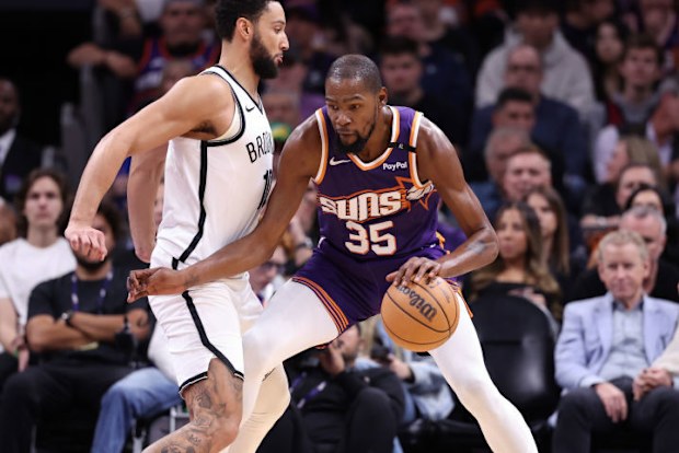 Kevin Durant #35 of the Phoenix Suns posts up on Ben Simmons #10 of the Brooklyn Nets.