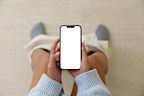 Woman holding a phone while using the toilet, Mock up phone  white screen display in hand