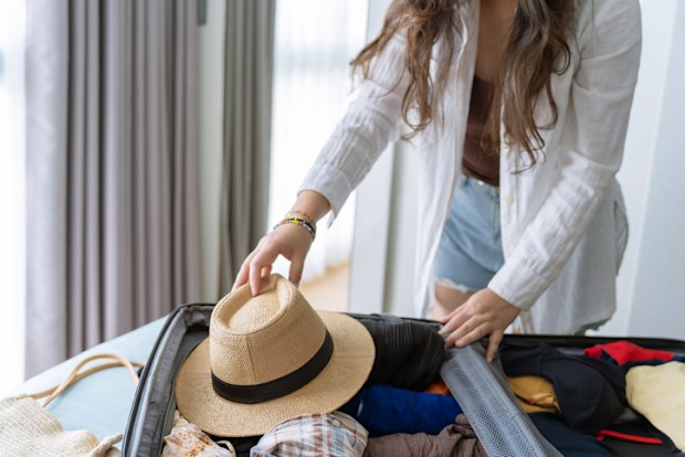 Woman packing suitcase