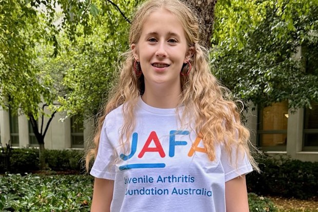 Laura Everson as a teen wearing a JAFA shirt.