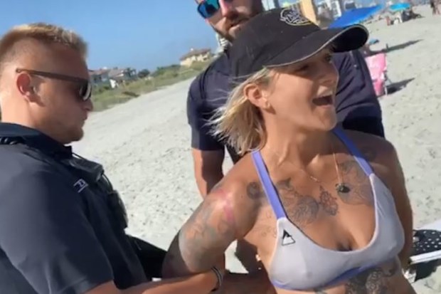 Woman handcuffed by police for wearing 'thong' swimsuit