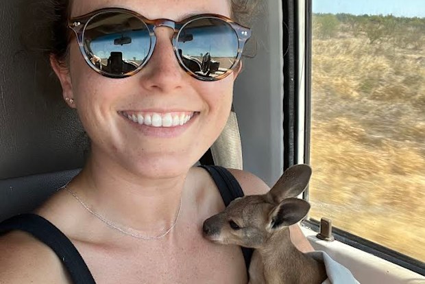 Laura Morgan cradling the orphaned joey.
