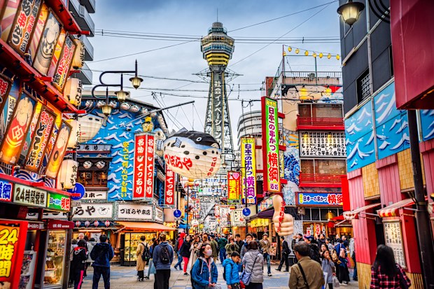 View of Osaka Tower and from Shinsekai district at dusk. Osaka, Japan.