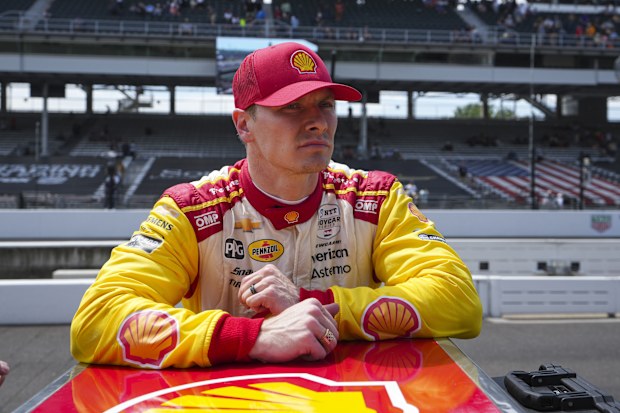 Josef Newgarden observes how his team stugs his car after training for the Indianapolis 500.