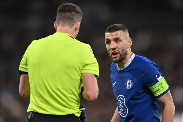 Referee Francois Letexier speaks to Mateo Kovacic of Chelsea.