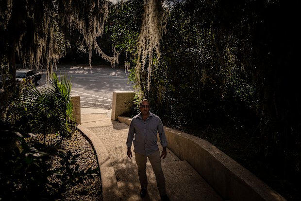 Joseph Moore stands for a portrait at a park.