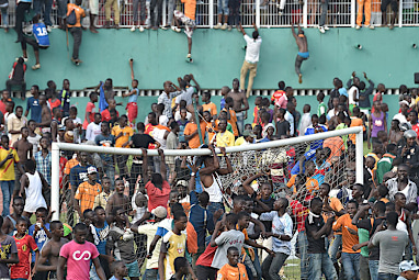 Jubilant supporters tear down the crossbar at one goal.
