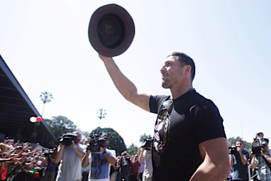 The battered warrior, Burgess, salutes the masses.