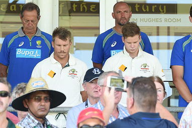 Dave Warner and Steve Smith respect a moments silence before start of play at the WACA.