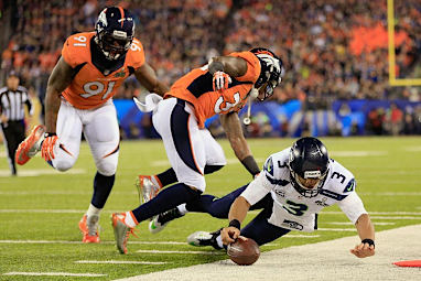 Seattle quarterback Russell Wilson tried in vain to keep their first drive alive.