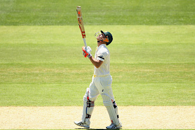 The opener raises his bat after reaching 63 in honour of Phillip Hughes.