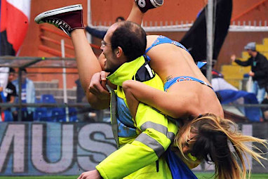 <b>Most of the time stadium security have to watch a rowdy crowd instead of the exciting game going on behind them, but one lucky guard had the responsibility of carrying a stunning streaker off the field.</b><br/><br/>The bikini-clad pitch invader at a Seria A game between UC Sampdoria and SSC Napoli was seen laughing as the guard took her off the grounds in a fireman's carry.<br/><br/>The streaking was reportedly organised by the club itself as a way to promote sales of season passes, an odd endorsement of a stunt most sporting organisations hate.