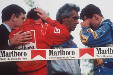 Drivers, including Michael Shumacher (far right) react to the news of his death.