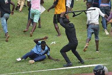 <b>Fans celebrating Ivory Coast's qualification for the Africa Cup of Nations have invaded the pitch where they were set upon by riot police in shocking scenes. </b><br/><br/>The Elephants clinched a berth in the tournament after a lacklustre draw with Cameroon, with jubilant fans mobbing the players and pulling down the crossbar at one end. <br/><br/>Photos have emerged of police striking supporters with batons in an attempt to get them off the pitch.<br/><br/>(All images Getty)