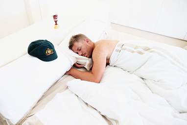 The images show him semi-naked under a sheet.