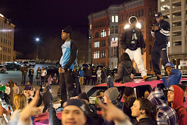 People climbed on cars to gain a better view.