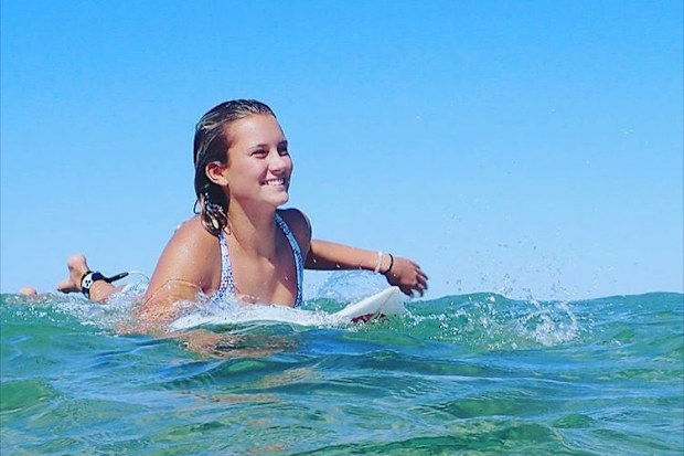 Kirra-Belle Olsson paddles out in the surf after the attack.