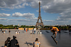 People stroll at Trocadero square near the Eiffel Tower in Paris, as France gradually lifts its Covid-19 lockdown. All city parks remain closed.