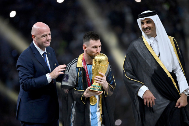 Lionel Messi of Argentina kisses the FIFA World Cup.