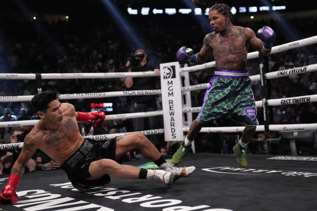Gervonta Davis knocks down Ryan Garcia during a lightweight boxing bout in Las Vegas.