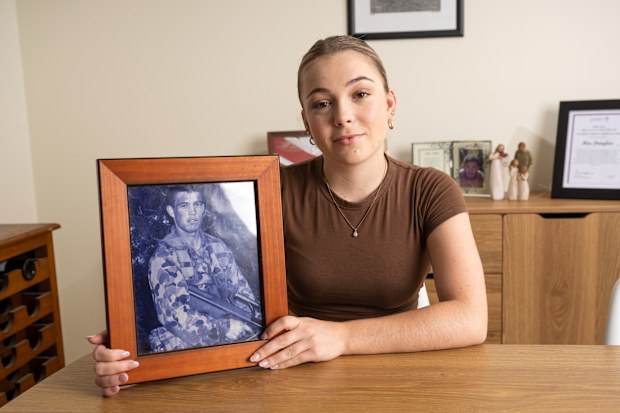Mia Douglas with a photo of her father Kevin.