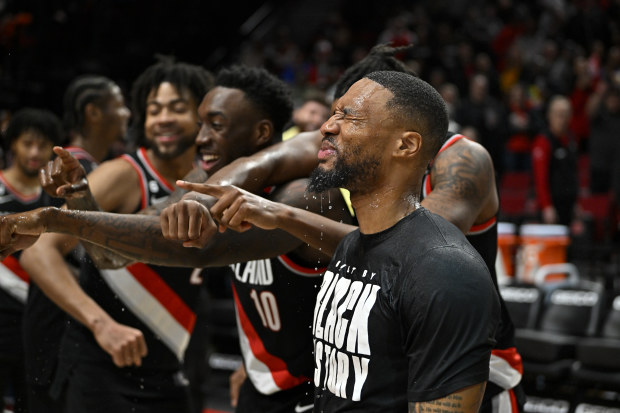 PORTLAND, OREGON - FEBRUARY 26: Damian Lillard #0 of the Portland Trail Blazers is doused by teammates after setting a franchise record 71 points in a single game that included 13 three-pointers against the Houston Rockets at the Moda Center on February 26, 2023 in Portland, Oregon. The Trail Blazers won 131-114. NOTE TO USER: User expressly acknowledges and agrees that, by downloading and or using this photograph, User is consenting to the terms and conditions of the Getty Images License Agreem
