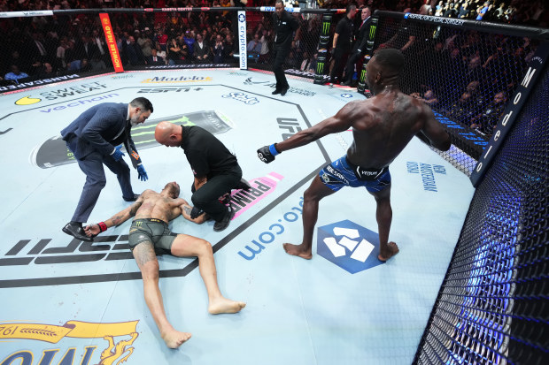 Israel Adesanya reacts after knocking out Alex Pereira in the UFC middleweight championship fight during the UFC 287 event.