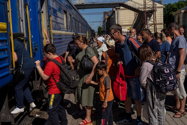 People board an evacuation train in Pokrovsk railway station, eastern Ukraine, Friday, June 10, 2022.