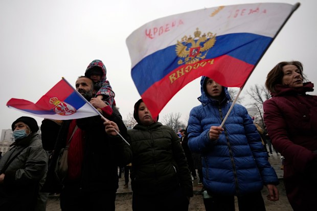 Supporters of Serbia's Novak Djokovic wave a Russian, right, and Serbian flags during a protest in Belgrade, Serbia, Saturday, Jan. 8, 2022.