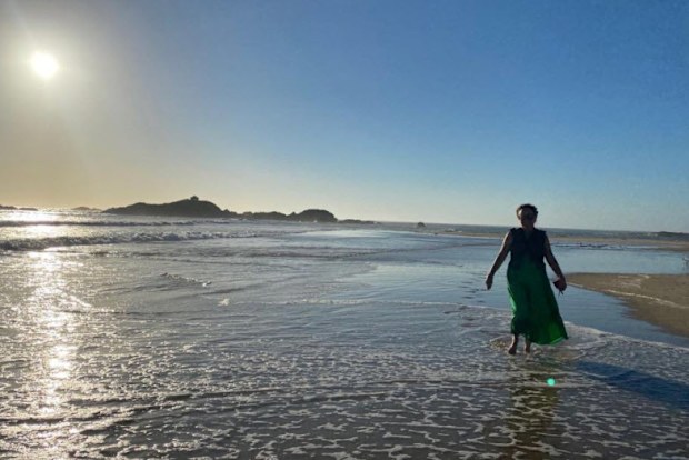 Nikki Gemmell walking in the water at the beach
