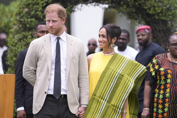 Prince Harry, left, and Meghan, right, holding hands upon arrival at the government house in Lagos Nigeria, Sunday, May 12, 2024. Prince Harry and his wife Meghan are in Nigeria to champion the Invictus Games, which Prince Harry founded to aid the rehabilitation of wounded and sick servicemembers and veterans. 