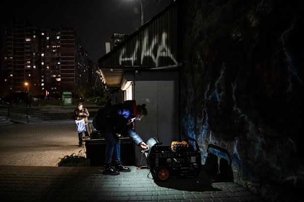 A woman looks at generator that powers a cafe if there is a power cut on November 05, 2022 in Kyiv, Ukraine. 