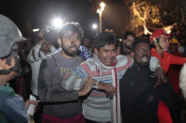 A Bangladeshi man cries for his missing sister outside a plastic factory on fire in Dhaka. (AP)