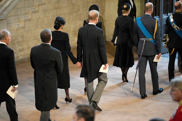 Prince Harry and his wife Meghan, the Duchess of Sussex leave after paying their respects to the coffin of Queen Elizabeth II in Westminster Hall for the Lying-in State, in London, Wednesday, Sept. 14, 2022. (David Ramos/Pool Photo via AP)