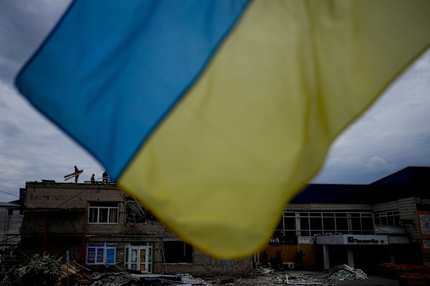 Men work at repairing a building damaged by shelling in Makariv, on the outskirts of Kyiv, Ukraine, Friday, May 27, 2022. (AP Photo/Natacha Pisarenko)