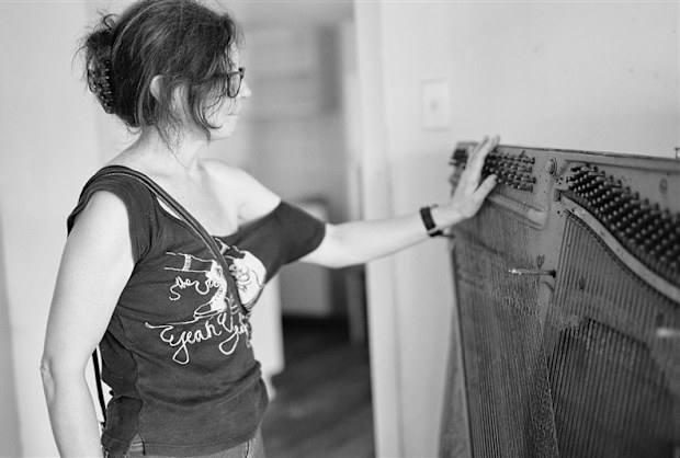 Rebecca Rushbrook assessing the heartbreaking loss of her 200 year old piano. 