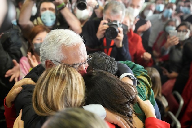 Portuguese Prime Minister and Socialist Party Secretary General Antonio Costa hugs his wife, daughter and son after delivering a speech following election results in which Portugal's center-left Socialist Party won a third straight general election, returning it to power, Lisbon, Monday, Jan. 31, 2022. 