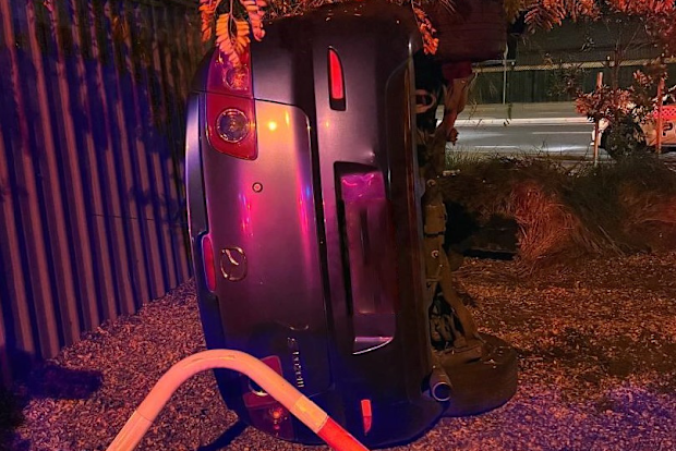 A car has rolled after a driver was distracted by an "i'll-timed kiss" in Glenelg North in Adelaide.