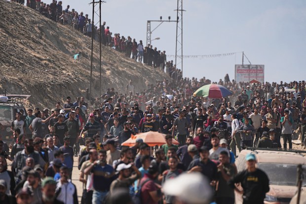 Displaced Palestinians walk along the coastal road near Wadi Gaza in the central Gaza Strip